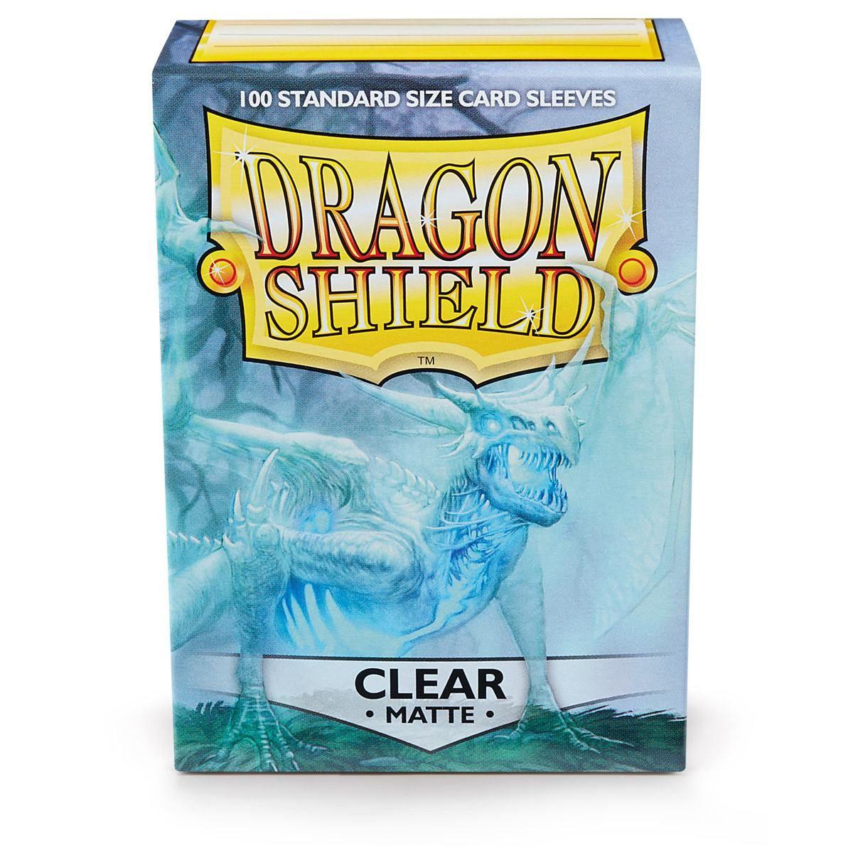 A box of durable Arcane Tinmen Dragon Shield: Standard 100ct Sleeves - Clear (Matte) is depicted. The box features a fierce dragon illustration in shades of blue and white. The top label reads 