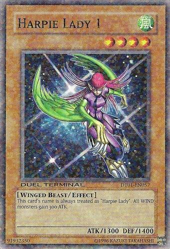 This Yu-Gi-Oh! card, "Harpie Lady 1," from Duel Terminal 1 (DT01-EN057) Common, portrays a humanoid winged creature in a purple outfit with red hair and green clawed wings. It is a WIND attribute Level 4 monster boasting 1300 ATK and 1400 DEF. Its special effect increases the ATK of all WIND monsters by 300.