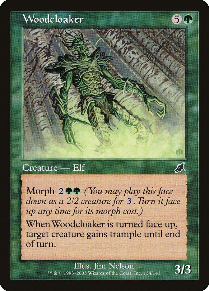 The Magic: The Gathering card "Woodcloaker [Scourge]" costs 5G to cast and is a 3/3 Elf creature. The card features an illustration of a green, armored elf adorned with roots and vines. Its ability text includes a Morph cost of 2GG, and when turned face up, it grants trample to a target creature until the end of the turn.