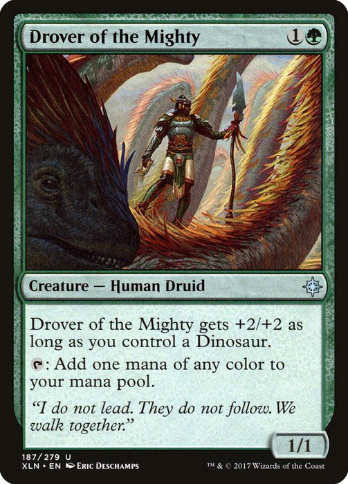 A "Drover of the Mighty [Ixalan]" Magic: The Gathering card showcases a Human Druid wielding a staff with a green gem. Costing 1 green and 1 generic mana, it has a power/toughness of 1/1 and gains +2/+2 if you control a Dinosaur. It can tap to add any mana color. Illustrated by Eric Deschamps.