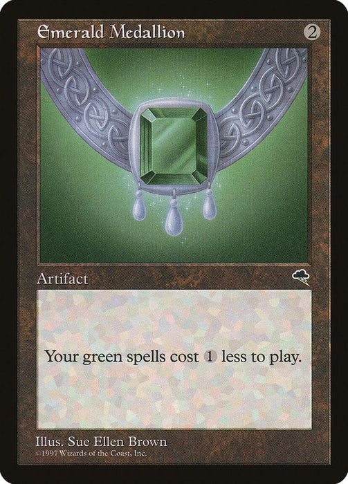 An Emerald Medallion [Tempest] Magic: The Gathering card from the Tempest set. It shows a green gemstone pendant with an intricate, silver chain on a green background. The text reads, "Your green spells cost 1 less to play." This artifact card has a brown border and was illustrated by Sue Ellen Brown in 1997.