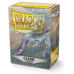 The Dragon Shield: Standard 100ct Sleeves - Clear (Classic) by Arcane Tinmen offers superior card protection with its glossy-backed sleeves. The box, featuring an illustration of a blue dragon with wings spread against a backdrop of cloudy skies, holds 100 standard-sized sleeves.