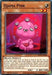 A Yu-Gi-Oh! trading card titled "Ojama Pink [BLVO-EN036] Common," featured in the Blazing Vortex set. This Effect Monster showcases a pink, alien-like creature with four eyes and a wide smile, holding a red heart-shaped object against a purple background with a pink aura. The card has 0 ATK and 1000 DEF points.