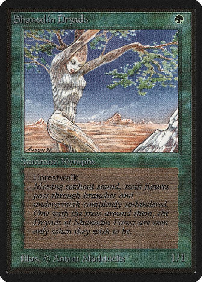 A Magic: The Gathering card named "Shanodin Dryads [Beta Edition]" features a tree-like Nymph Dryad in Shanodin Forest. The green-framed card depicts her bark-textured skin and branch-like hair. The text box describes the "Forestwalk" ability and flavor text, with art by Anson Maddocks.