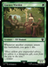 The image is of the Magic: The Gathering card "Essence Warden [The Lord of the Rings: Tales of Middle-Earth Commander]." It features a vibrant, forest setting with an Elf Shaman in the foreground, clad in a flowing green dress, sitting on a wooden bench adorned with flowers. The bottom half of the card details the card's properties and abilities.