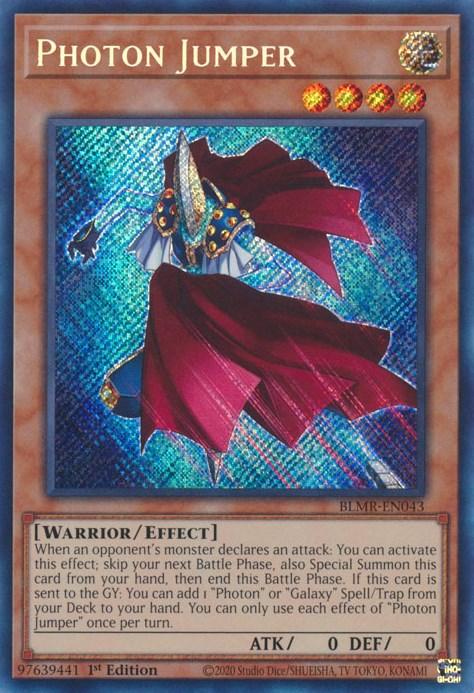A Yu-Gi-Oh! trading card titled “Photon Jumper [BLMR-EN043] Secret Rare” features an armored warrior with a blue and gold color scheme, donning a red cape. As an Effect Monster, its card text describes special abilities for summoning. With 0 ATK and 0 DEF points, this 1st edition card boasts a holographic background.