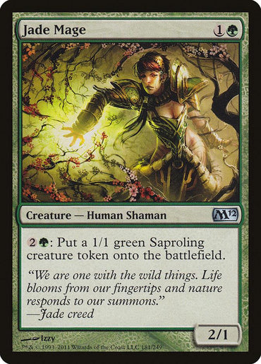 A Magic: The Gathering card titled "Jade Mage" from the Magic 2012 set has a casting cost of 1 green mana and 1 colorless mana. It features a Human Shaman with green magic flowing from their hands amidst lush foliage. For 2 and 1 green mana, the card allows you to create a 1/1 green Saproling creature token.