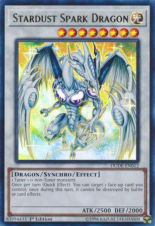 A Yu-Gi-Oh! trading card titled "Stardust Spark Dragon [DUDE-EN012] Ultra Rare" from the Duel Devastator series. This Ultra Rare Synchro/Effect Monster showcases a large, armored dragon with glowing blue and white scales. It has eight stars, 2500 ATK, and 2000 DEF, along with a special ability description.