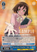 The Character Card showcases an anime-style illustration of a young female teacher with short brown hair and green eyes. Wearing a white blouse with a pink bow, she holds a book in her left hand while her right hand reaches forward. Named "Protective Teacher, Aiko (ARI/S103-E072 RR) [Arifureta: From Commonplace to World's Strongest]," this Double Rare card from Bushiroad adds value to any Arifureta collection.
