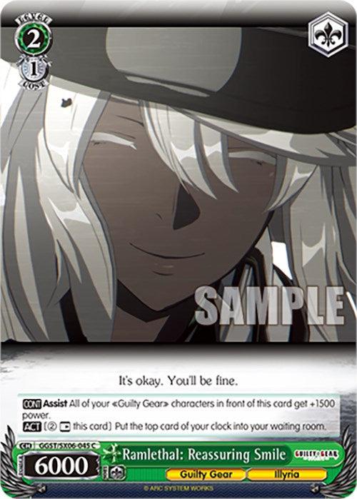 A trading card featuring Ramlethal from Guilty Gear: Strive with long white hair and a black hat. She is smiling softly with closed eyes. Text on the card includes "Ramlethal: Reassuring Smile (GGST/SX06-045 C)" [Guilty Gear -Strive- by Bushiroad] and "It's okay. You'll be fine." The character card has stats: Level 2, Cost 1, Power 6000, from the Illyria set