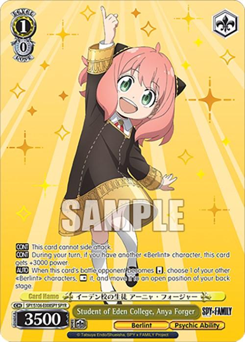 A trading card features Student of Eden College, Anya Forger (SPY/S106-E008SPY SPYR) [SPY x FAMILY]. Anya, with her pink hair and black hair clips, has wide-open green eyes and a cheerful smile. She wears a black dress with gold accents. The yellow background with star designs highlights her Psychic Ability stats and Spy Rare details. This card is from Bushiroad.