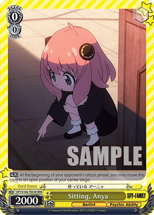 A trading card from the game "Weiss Schwarz," featuring a character named Anya from "SPY x FAMILY." Anya, with pink hair and black attire, is sitting on the floor, pointing at something. The card has a yellow border with stats and abilities in text at the bottom, highlighting her Psychic Ability. "SAMPLE" is prominently displayed across the image. The product name is Sitting, Anya (SPY/S106-TE03R RRR) [SPY x FAMILY] by Bushiroad.