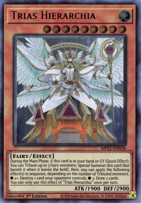 The image shows the Trias Hierarchia [MP21-EN058] Ultra Rare Yu-Gi-Oh! trading card. It's a Level 9 Ultra Rare Fairy-type monster with 1900 ATK and 2900 DEF. The card features an armored angelic figure with a golden halo, wings spread wide, holding a staff, and includes effect text and various stats.