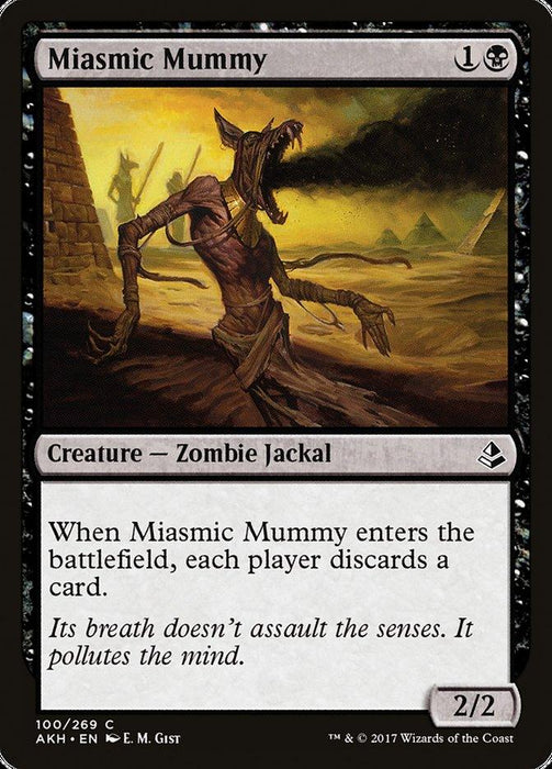 A Magic: The Gathering card titled "Miasmic Mummy [Amonkhet]." This 2/2 black Zombie Jackal creature costs 1B to cast. The illustration depicts a mummy emitting black fumes in a desert. When it enters the battlefield, each player discards a card. Flavor text: "It pollutes the mind.