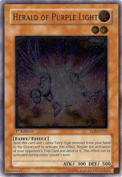 The "Herald of Purple Light [EOJ-EN019] Ultimate Rare" from the Yu-Gi-Oh! brand features an orange-framed card showcasing a fairy-like creature with wings in a glowing, ethereal form. This 1st Edition Effect Monster, characterized by its Fairy/Effect attributes, boasts 300 ATK and 500 DEF. The card details an effect involving the sending of Trap Cards to the graveyard.