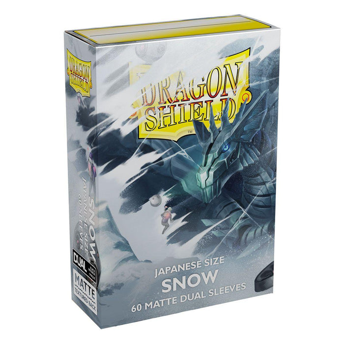 The image shows an Arcane Tinmen brand box of Dragon Shield: Japanese Size 60ct Sleeves - Snow (Dual Matte) designed for Japanese-sized cards. The box has a snowy theme with a blue and white dragon on the front. The words "Dragon Shield" and "Snow" are prominently displayed on the box.