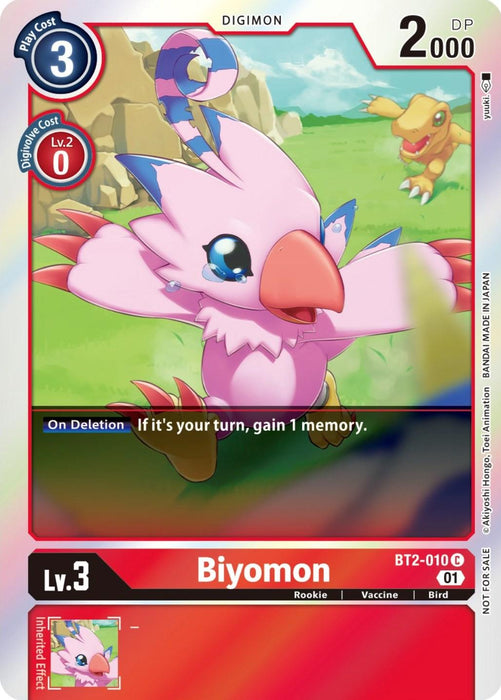 The Digimon card titled Biyomon [BT2-010] from the ST-11 Special Entry Pack of the Release Special Booster Promos features Biyomon, a pink bird-like Rookie creature with blue eyes and red claws. The card showcases its stats: Play Cost 3, Level 2 Digivolve Cost 0, and 2000 DP. In the background, there's a yellow dinosaur-like Digimon. Card number BT2-010 C has an additional text that reads, "If it’s your turn, gain 1 memory.