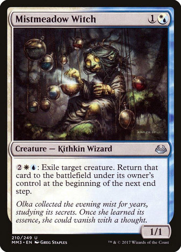 The Magic: The Gathering card "Mistmeadow Witch" from the Modern Masters 2017 set features artwork depicting a creepy, green-skinned Kithkin Wizard seated on a branch, surrounded by floating orbs. With a casting cost of 1 blue or white mana and abilities that include exiling target creatures, this 1/1 powerhouse stands out.