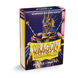 A box of Dragon Shield: Japanese Size 60ct Sleeves - Purple (Matte) by Arcane Tinmen. The packaging showcases an armored dragon figure wielding two swords and features the text "60 Japanese Size Card Sleeves" at the top. The "Dragon Shield" logo is prominently displayed on the front, ensuring quality and protection for your cards.