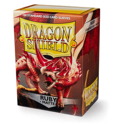 The Dragon Shield: Standard 100ct Sleeves - Ruby (Matte) by Arcane Tinmen showcases a red dragon with wings in flames, labeled "Ruby Matte." It contains 100 standard card sleeves, with a bright yellow logo on a dark reddish background.