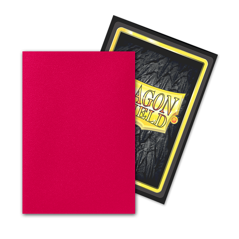 A red-backed card and another with a textured dark pattern and yellow-gold border are encased in Dragon Shield: Japanese Size 60ct Sleeves - Fury (Dual Matte) by Arcane Tinmen, both inscribed "DRAGON FIELD" in a stylized font, resting on a transparent backdrop.