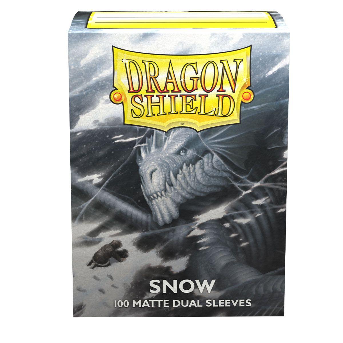 The Arcane Tinmen Dragon Shield: Standard 100ct Sleeves - Snow (Dual Matte) features a black interior with artwork of an icy dragon in a snowstorm and a tiny figure braving the snow. Text on the front reads 