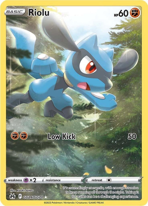 A Pokémon card featuring Riolu (GG26/GG70) [Sword & Shield: Crown Zenith], a blue and black canine-like creature with large ears and red eyes. The card text shows it has 60 HP and an attack called "Low Kick" that does 50 damage. This Holo Rare from the Crown Zenith set is set against a forest background with sunlight filtering through the trees.