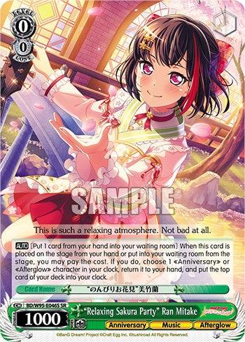 A trading card features "Relaxing Sakura Party" Ran Mitake [BanG Dream! Girls Band Party! 5th Anniversary] dressed in an elegant pink and white outfit with frills and a red ribbon. She is in a sakura-themed setting, holding a sakura branch and smiling warmly. This super rare, 5th-anniversary card includes stats, abilities, and text in English and Japanese.