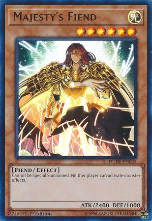 An image of the "Majesty's Fiend [DUDE-EN035] Ultra Rare" Yu-Gi-Oh! trading card. The Ultra Rare card depicts a radiant, armor-clad humanoid figure with long hair and large glowing wings. It has 6 stars, a Light attribute with an attack power of 2400 and defense of 1000. Created by Kazuki Takahashi.