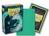 The image showcases a box of Arcane Tinmen's Dragon Shield: Japanese Size 60ct Sleeves - Aurora (Matte), featuring 60 matte sleeves. The front of the box displays a white dragon with an aqua theme. One sleeve is out of the box, highlighting its green matte side and the intricate dragon design on the back.