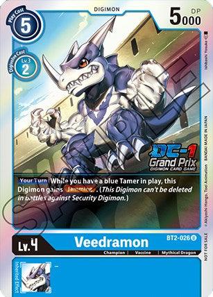 Image of a Digimon trading card for "Veedramon [BT2-026] (DC-1 Grand Prix) [Release Special Booster Promos]." With a blue border, it features a humanoid, mythical dragon-like creature with white and blue armor, flexing its muscles and roaring. The promo card attributes: Level 4, 5000 DP, involving a blue Tamer. Texts: "BT2-026" and "DC-1 Grand Prix.