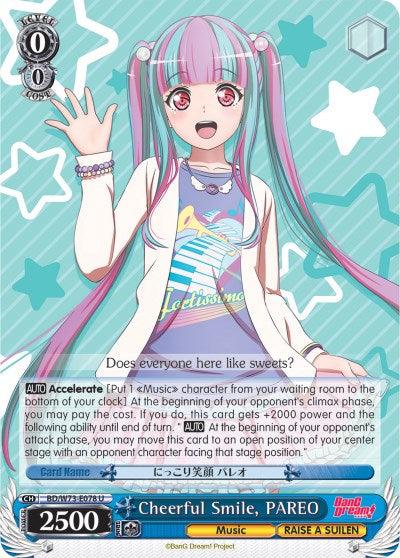 A trading card from BanG Dream! Vol.2 features an anime-style girl with long pink and blue hair in twin tails, wearing a white shirt with blue and pink accents. The text at the bottom reads "Cheerful Smile, PAREO," from the band RAISE A SUILEN. Below are card details including a 0-cost, 0-soul value. This product is officially named "Cheerful Smile, PAREO (BD/W73-E078 U) [BanG Dream! Vol.2]" by Bushiroad.