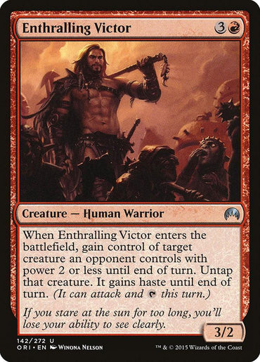 Featured in the Magic Origins set, "Enthralling Victor" from Magic: The Gathering presents a human warrior with flowing hair, triumphantly holding his weapon amidst allies in a fiery red haze. This card requires a mana cost of 3R and has a power/toughness rating of 3/2, along with an intriguing special ability.