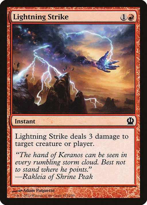 A "Magic: The Gathering" card titled "Lightning Strike [Theros]." The card, set in Theros, depicts a stormy sky with a lightning bolt emanating from a hand-shaped cloud. It's an Instant spell that costs 1 red mana and 1 generic mana, dealing 3 damage to any target. The flavor text references the hand of Keranos.