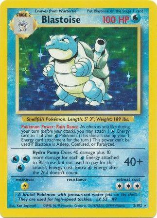 An image of a Blastoise (2/102) [Base Set Unlimited] Pokémon card from the Base Set Unlimited series. The card, a Holo Rare, is blue with a yellow border and features an illustration of Blastoise, a large blue turtle-like creature with water cannons on its back. Blastoise has 100 HP and is a Stage 2 Water-type Pokémon. The card text details its abilities: Rain Dance and