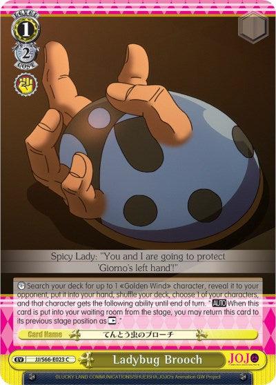 A "JoJo's Bizarre Adventure: Golden Wind" event card featuring the Ladybug Brooch (JJ/S66-E023 C) [JoJo's Bizarre Adventure: Golden Wind]. The card shows a hand holding a blue and pink spotted brooch. The top text reads: "Spicy Lady: 'You and I are going to protect Giorno's left hand'." The card effects are detailed in the text box below. This card is produced by Bushiroad.