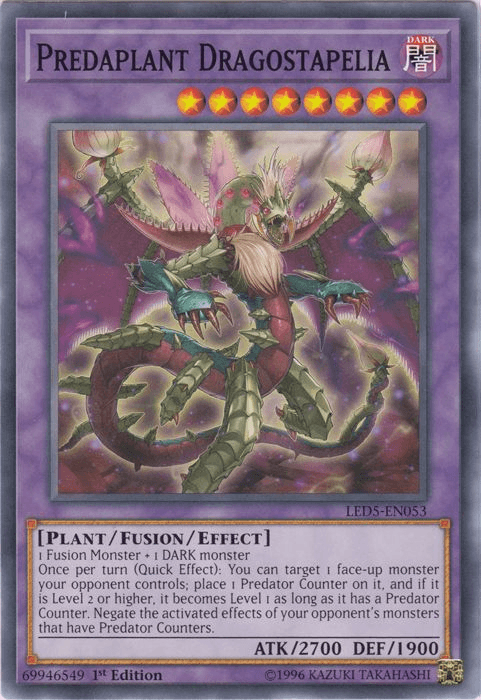 Image of the Yu-Gi-Oh! card "Predaplant Dragostapelia [LED5-EN053] Common." The card features a dark, plant-like creature with multiple heads and tentacles. Its stats are ATK/2700 and DEF/1900. This level 8 dark attribute legendary duelists' fusion/effect monster includes an effect for placing Predator Counters.
