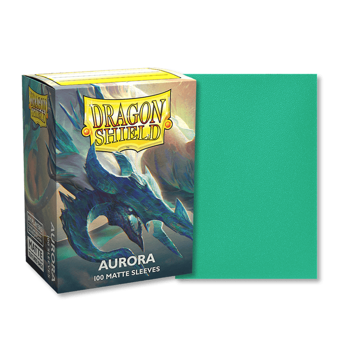 Image of a box of Dragon Shield: Standard 100ct Sleeves - Aurora (Matte) by Arcane Tinmen. The box features a dragon illustration with the text "Dragon Shield" at the top and "Aurora 100 Matte Sleeves" at the bottom. Next to the box is one of the card sleeves, displayed in a solid teal color.