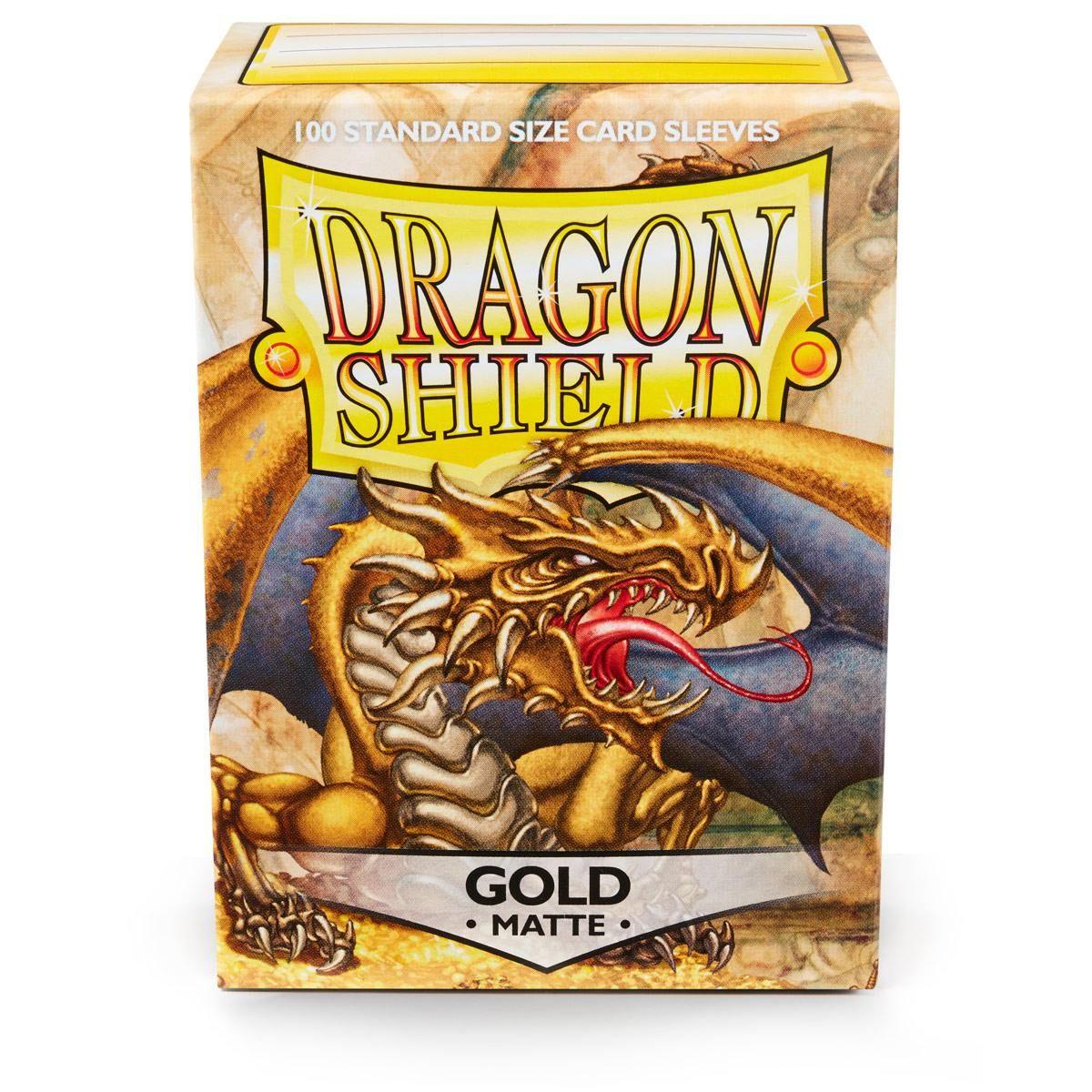 A box of Dragon Shield: Standard 100ct Sleeves - Gold (Matte) by Arcane Tinmen is depicted. The gold box features an illustration of a dragon with wings, claws, and an open mouth. Text at the top reads 