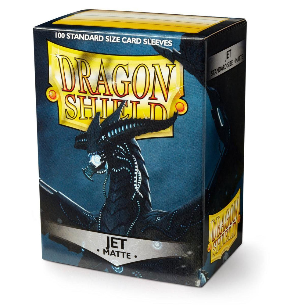 A box of Arcane Tinmen’s Dragon Shield: Standard 100ct Sleeves - Jet (Matte), featuring a menacing black dragon with glowing blue eyes against a dark background. Known for their durable quality, the front prominently displays the Dragon Shield logo along with "100 Standard Size Card Sleeves" at the top.