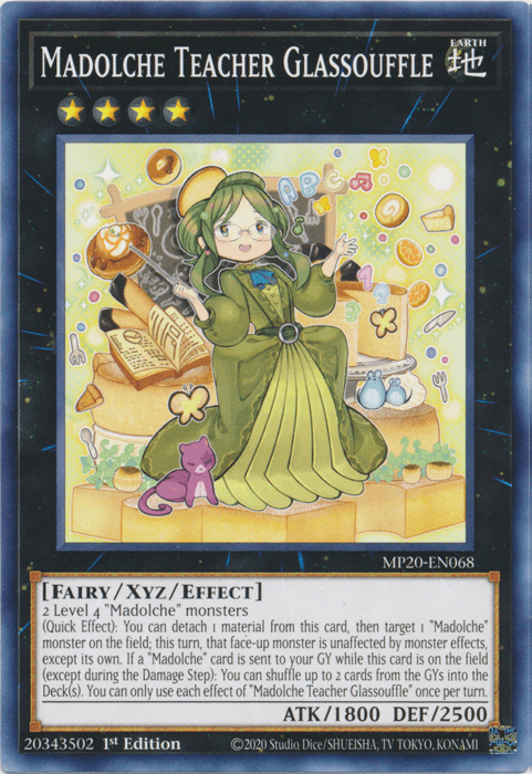 A trading card featuring "Madolche Teacher Glassouffle [MP20-EN068] Common," a character from the Yu-Gi-Oh! series. This Xyz/Effect Monster, from the 2020 Tin of Lost Memories, is adorned with an ornate design, showcasing a spell-casting female character joyfully posed with cakes and pastries, detailing her stats and abilities.