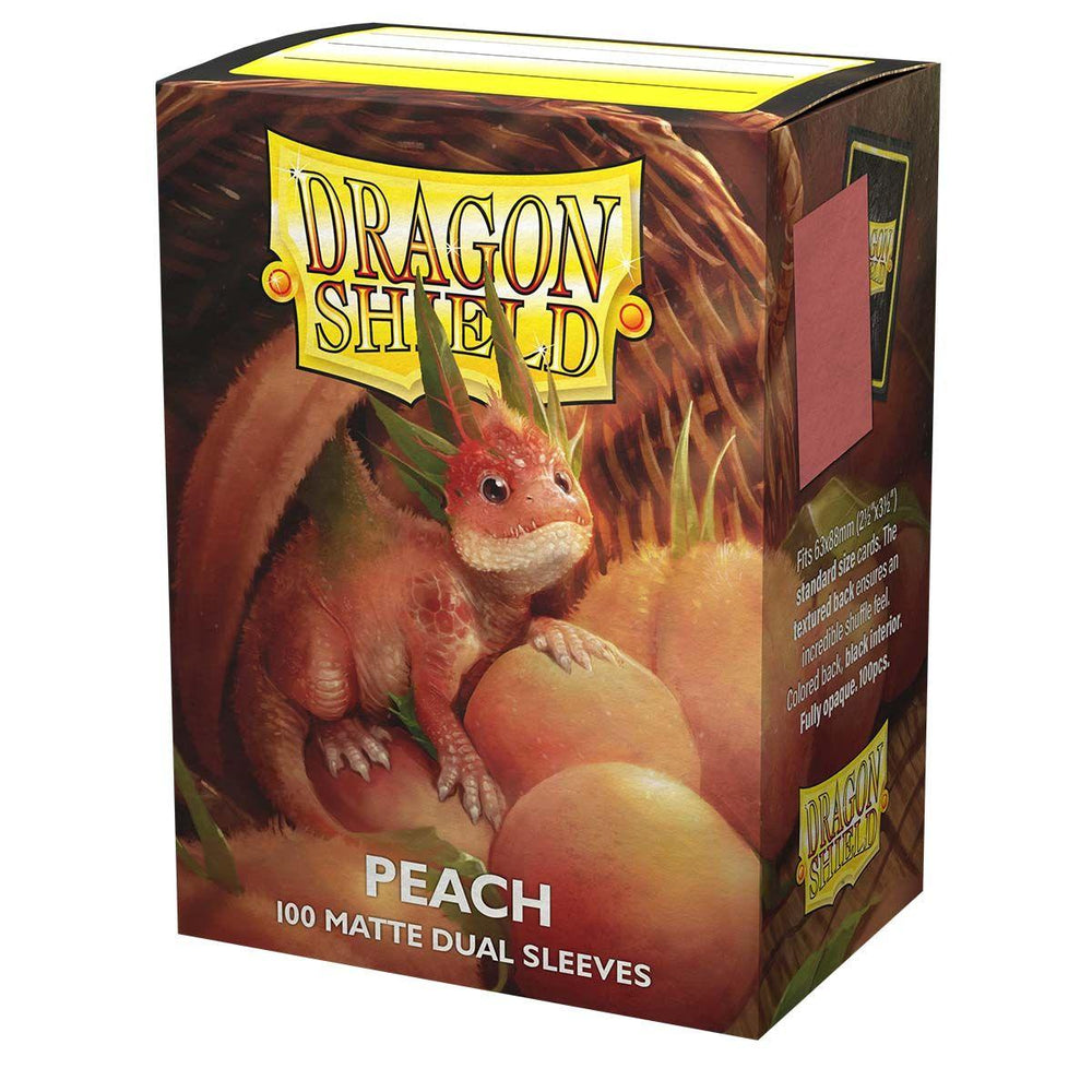 A box of Dragon Shield: Standard 100ct Sleeves - Peach (Dual Matte) by Arcane Tinmen in the Peach color variant. The sturdy cardboard box features an illustration of a small, peach-colored fantasy dragon sitting among peaches. The Dragon Shield logo is prominently displayed near the top, and the sleeves have a black interior for added elegance.