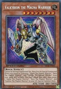 The image depicts the "Valkyrion the Magna Warrior (Secret) [SBCB-EN022] Secret Rare" Yu-Gi-Oh! trading card from the Speed Duel: Battle City Box. The Secret Rare card features an armored robot warrior holding a sword and shield. It has an orange background with intricate designs and displays its impressive ATK of 3500 and DEF of 3850.