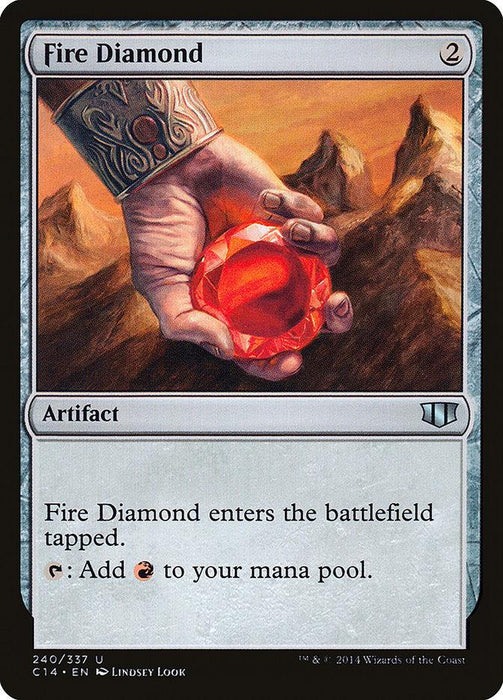 A Magic: The Gathering product named Fire Diamond [Commander 2014]. The illustration shows a hand holding a glowing red gemstone against rugged mountains and a fiery sky. The card text reads: "Fire Diamond enters the battlefield tapped. {T}: Add {R} to your mana pool." It costs 2 mana to cast.