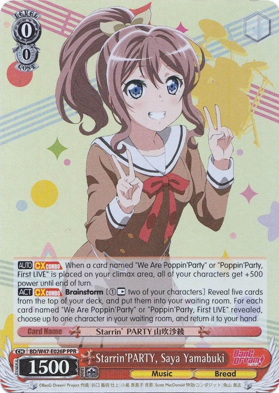 A trading card featuring Saya Yamabuki from the BanG Dream! series, part of the Poppin'Party band. She has brown hair tied in two ponytails and is wearing a school uniform with a blue plaid skirt. Smiling and holding up a peace sign with both hands, text on this promo card details her abilities and stats. The product name is Starrin'PARTY, Saya Yamabuki (BD/W47-E026P PPR) (Parallel Foil) (Promo) [Bushiroad Event Cards] by Bushiroad.