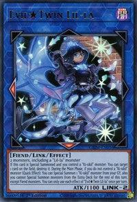A Yu-Gi-Oh! trading card titled "Evil Twin Lil-la [GEIM-EN016] Ultra Rare" features a dark-clad girl with blue highlights and a mechanical, dragon-like creature. This Link/Effect Monster has a blue border and detailed artwork of the character. Text describes its abilities and attributes, including "Fiend/Link/Effect" and "ATK/1100 LINK-2.