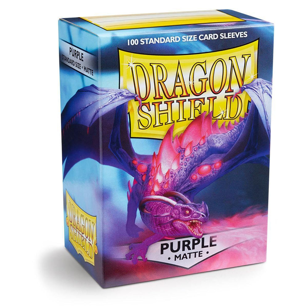 A colorful box of Arcane Tinmen Dragon Shield: Standard 100ct Sleeves - Purple (Matte). The front shows a fierce purple dragon with red eyes and a vibrant, scaly body. The background has a gradient of blue to purple hues with smoke effects. The box states "100 Durable Card Sleeves" and "Purple - Matte" at the bottom.