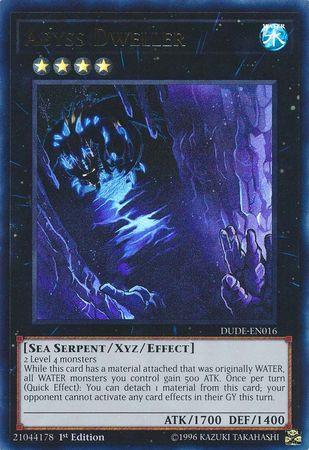 A trading card showcasing the Ultra Rare "Abyss Dweller [DUDE-EN016] Ultra Rare" from Yu-Gi-Oh!, a shadowy blue entity engulfed by dark, swirling waters. This Sea Serpent Xyz/Effect Monster boasts 1700 ATK and 1400 DEF, requiring 2 level 4 monsters to summon. Its effect notably boosts the ATK of all WATER monsters by 500.