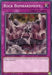 Image of a Yu-Gi-Oh! card named "Rock Bombardment [SBCB-EN037] Common," a Normal Trap from the Battle City Box. It's a purple Trap Card featuring rocks being hurled from a castle-like structure towards an unseen target. The card text reads, "Send 1 Rock monster from your Deck to the GY; inflict 500 damage to your opponent.