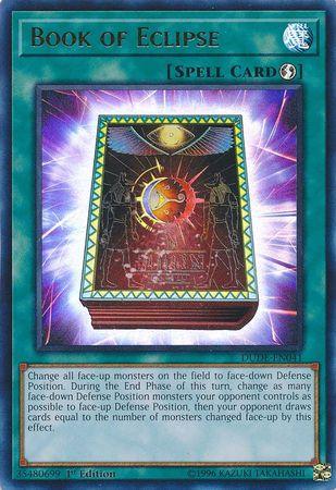 A Yu-Gi-Oh! Spell Card named "Book of Eclipse [DUDE-EN041] Ultra Rare" is depicted. This Ultra Rare Quick Play Spell features an illustration of an ancient book with a glowing, magical aura. The background shows a celestial motif with stars and a colorful nebula, reminiscent of the epic Duel Devastator series. The card's effect and description text are visible below the image.